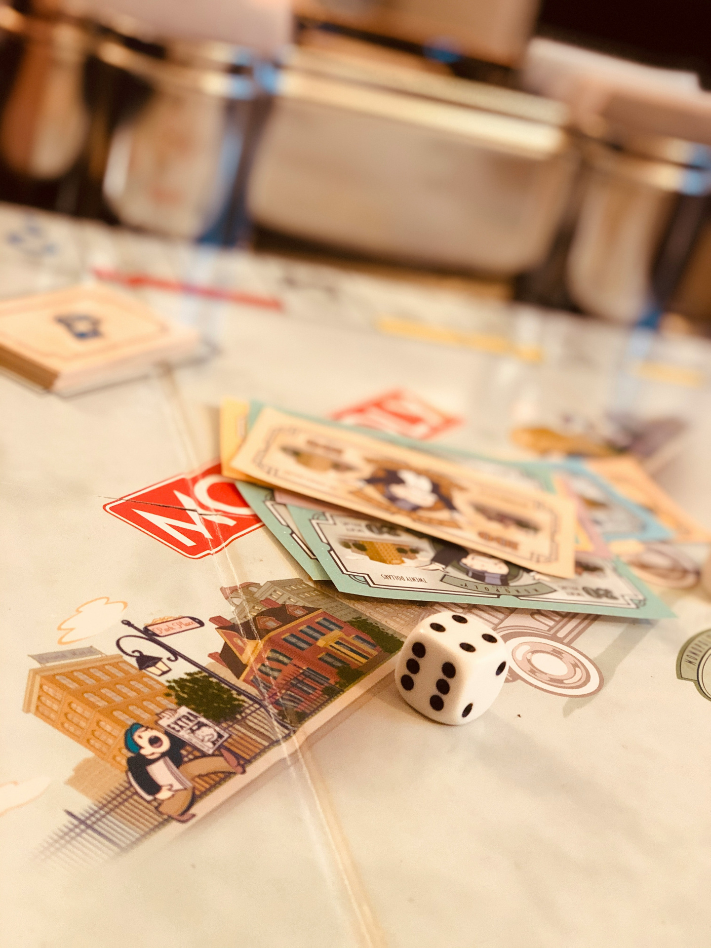 Board game pieces, dice and cards on a table